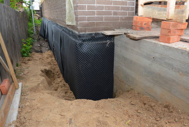 Happy homeowners after waterproofing job in East Aurora